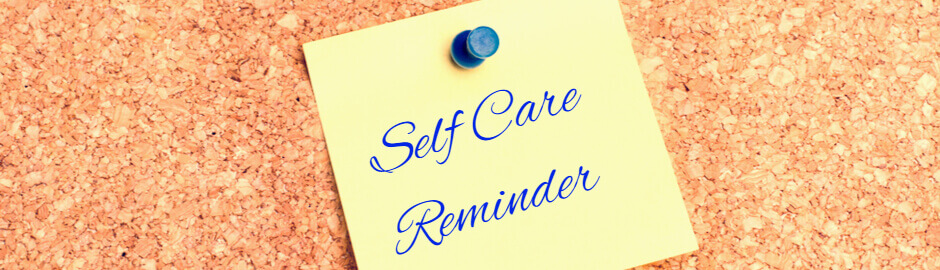Self Care reminder written in blue ink on yellow sticky note
